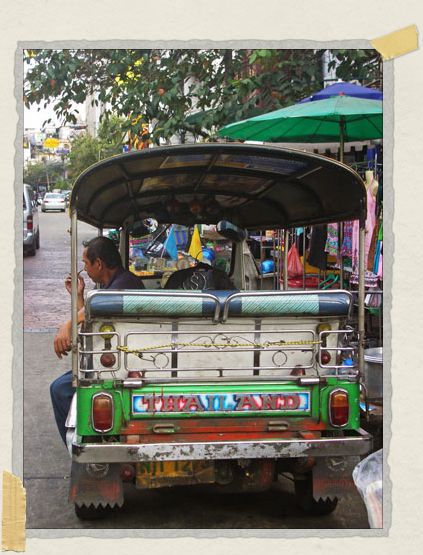 'A tuk-tuk (basically a golf cart on steroids) driver waits for his next customer