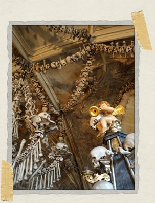 'A doughy cherub sits atop a pile of skulls with his horn in one hand and another skull in the other